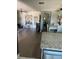 Open living space with hardwood floors leading from the kitchen to the living area at 9622 Brassie Ct # 9, New Port Richey, FL 34655