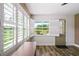 Bright room with plantation shutters overlooking the golf course and sleek wood-look flooring at 9622 Brassie Ct # 9, New Port Richey, FL 34655