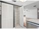 Bright kitchen pantry features white shelving, tiled floor, and white bi-fold doors at 9622 Brassie Ct # 9, New Port Richey, FL 34655