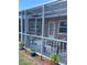 A screened-in patio with seating, surrounded by plants at 9622 Brassie Ct # 9, New Port Richey, FL 34655