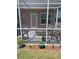 Enclosed patio with outdoor seating and potted plants, set in a well-manicured yard at 9622 Brassie Ct # 9, New Port Richey, FL 34655