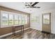 Bright sunroom featuring plantation shutters, stylish ceiling fan, and wood-look floors at 9622 Brassie Ct # 9, New Port Richey, FL 34655