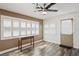 Bright sunroom featuring plantation shutters, stylish ceiling fan, and wood-look floors at 9622 Brassie Ct # 9, New Port Richey, FL 34655