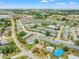 Wide aerial shot showcasing the neighborhood with community pool at 9891 52Nd N St, Pinellas Park, FL 33782