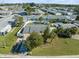 Aerial view showcasing the property's fully fenced backyard and mature trees at 9891 52Nd N St, Pinellas Park, FL 33782
