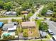 Aerial view of a single-Gathering home with a fenced backyard, fire pit and proximity to neighborhood amenities at 9891 52Nd N St, Pinellas Park, FL 33782