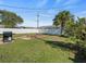 Fully fenced backyard with a grill, fire pit and lush lawn at 9891 52Nd N St, Pinellas Park, FL 33782