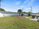 Large backyard featuring a fire pit, grill, and well-maintained lawn at 9891 52Nd N St, Pinellas Park, FL 33782