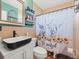 Stylish bathroom featuring modern fixtures, decorative mirror and unique shower curtain at 9891 52Nd N St, Pinellas Park, FL 33782