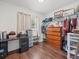 Bedroom featuring wooden floors, a desk, dresser, and closet for optimal storage at 9891 52Nd N St, Pinellas Park, FL 33782