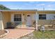Close-up view of the home's entrance, featuring a brick patio and seating at 9891 52Nd N St, Pinellas Park, FL 33782