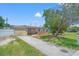 Single-story home with well-manicured lawn and mature landscaping at 9891 52Nd N St, Pinellas Park, FL 33782