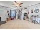 Cozy living room with tiled flooring, ceiling fan, and an open doorway at 9891 52Nd N St, Pinellas Park, FL 33782