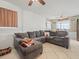 Spacious living room featuring a large sectional sofa and neutral tile flooring at 9891 52Nd N St, Pinellas Park, FL 33782