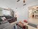 Open living room with tile floors, ceiling fan, and seamless flow to other areas at 9891 52Nd N St, Pinellas Park, FL 33782