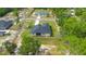 Aerial view of home showcasing yard, and street in a wooded neighborhood at 10380 Yellow Hammer Rd, Weeki Wachee, FL 34614