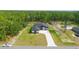 Aerial view of a well manicured home with mature trees on a lush green lot at 10380 Yellow Hammer Rd, Weeki Wachee, FL 34614