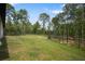 Wide open backyard with mature trees and a fence perfect for outdoor activities at 10380 Yellow Hammer Rd, Weeki Wachee, FL 34614