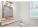 Bright bathroom with marble countertops, modern fixtures, and a large framed mirror at 10380 Yellow Hammer Rd, Weeki Wachee, FL 34614