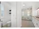 Modern bathroom featuring a sleek toilet and a luxurious shower with marble-patterned walls at 10380 Yellow Hammer Rd, Weeki Wachee, FL 34614