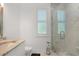 Modern bathroom with marble shower, glass door, and sleek fixtures at 10380 Yellow Hammer Rd, Weeki Wachee, FL 34614