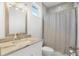 Bathroom featuring granite countertops, modern fixtures, and a shower with gray tiling at 10380 Yellow Hammer Rd, Weeki Wachee, FL 34614