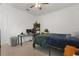 Cozy bedroom featuring a ceiling fan, a workspace, and light wood floors at 10380 Yellow Hammer Rd, Weeki Wachee, FL 34614