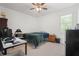 Bright bedroom with a ceiling fan, large window, and a comfortable sleeping space at 10380 Yellow Hammer Rd, Weeki Wachee, FL 34614