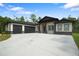 Spacious single story home featuring a three car garage and craftsman-style architecture at 10380 Yellow Hammer Rd, Weeki Wachee, FL 34614