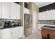 Bright kitchen featuring a stainless refrigerator, granite counters, and decorative backsplash at 10380 Yellow Hammer Rd, Weeki Wachee, FL 34614