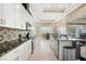 Open kitchen featuring granite countertops, stainless steel appliances and seamless access to the dining area at 10380 Yellow Hammer Rd, Weeki Wachee, FL 34614