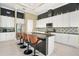 Bright kitchen with modern countertops, island with seating, stainless steel appliances and stylish backsplash at 10380 Yellow Hammer Rd, Weeki Wachee, FL 34614