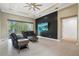 Spacious staged living room with sliders to the lanai, a black accent wall, and recessed lighting at 10380 Yellow Hammer Rd, Weeki Wachee, FL 34614