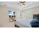 Spacious main bedroom with tray ceilings, ceiling fan, and an entertainment center with large screen TV at 10380 Yellow Hammer Rd, Weeki Wachee, FL 34614