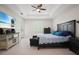 Spacious main bedroom with tray ceilings, ceiling fan, and an entertainment center with large screen TV at 10380 Yellow Hammer Rd, Weeki Wachee, FL 34614