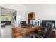 Executive office with a classic desk, leather chairs, and views into the living room area at 10380 Yellow Hammer Rd, Weeki Wachee, FL 34614