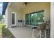 Enjoy this outdoor patio with ceiling fan, table and chairs through the sliding glass doors at 10380 Yellow Hammer Rd, Weeki Wachee, FL 34614