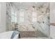 Stunning glass-enclosed shower with marble tile, rain shower head, and separate soaking tub at 10380 Yellow Hammer Rd, Weeki Wachee, FL 34614