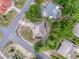 An aerial view shows the home's location on a corner lot in a residential neighborhood with mature landscaping at 10411 Ireland St, Spring Hill, FL 34608