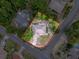 An aerial view shows the perimeter of the home, surrounded by trees and located on a corner lot at 10411 Ireland St, Spring Hill, FL 34608