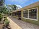 Cozy outdoor patio area with brick flooring and lush green garden area at 10411 Ireland St, Spring Hill, FL 34608