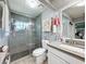 Updated bathroom features a glass-enclosed shower, modern vanity, and stylish grey and white tile at 10411 Ireland St, Spring Hill, FL 34608