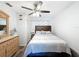 Cozy bedroom with warm wood accents, ceiling fan, and natural light at 10411 Ireland St, Spring Hill, FL 34608