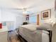 Comfortable bedroom featuring hardwood floors, soft natural light and a ceiling fan at 10411 Ireland St, Spring Hill, FL 34608
