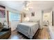 Comfortable bedroom featuring hardwood floors, ceiling fan and relaxing natural light at 10411 Ireland St, Spring Hill, FL 34608