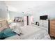 Cozy bedroom featuring neutral tones, light blue walls, and natural light from slider and window at 10411 Ireland St, Spring Hill, FL 34608