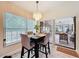 Eat in breakfast nook with modern lighting fixture, outdoor view, and door to sun room at 10411 Ireland St, Spring Hill, FL 34608