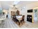 Bright dining room with skylight, ceiling fan, wood table and chairs, and seamless flow into the kitchen at 10411 Ireland St, Spring Hill, FL 34608