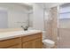 Bathroom with shower and glass door, and a large mirror above a sink at 10441 Mayflower Rd, Spring Hill, FL 34608