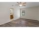 Bright bedroom features neutral walls, a ceiling fan, and sleek wood-look flooring at 10441 Mayflower Rd, Spring Hill, FL 34608